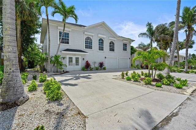 21075 Saint Peters Dr S, Fort Myers Beach, FL 33931 - view of front of home featuring concrete driveway, an attached garage, and french doors