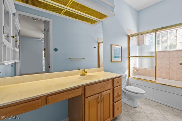 21075 Saint Peters Dr S, Fort Myers Beach, FL 33931 - bathroom with toilet, vanity, tile patterned flooring, shower / bath combination with glass door, and ceiling fan