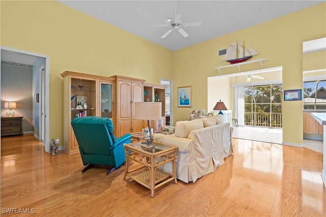 21075 Saint Peters Dr S, Fort Myers Beach, FL 33931 - living area featuring ceiling fan, a high ceiling, light wood-style floors, and baseboards