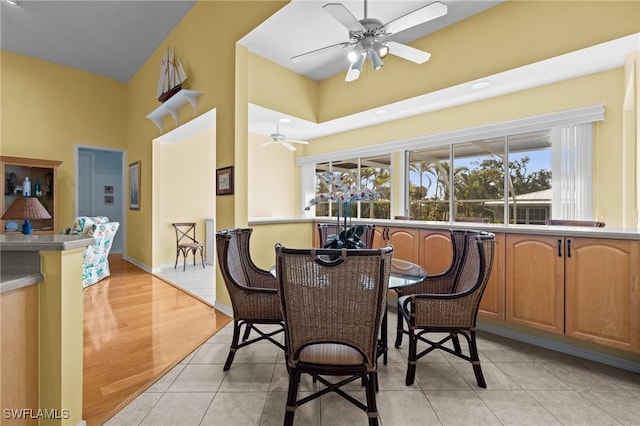 21075 Saint Peters Dr S, Fort Myers Beach, FL 33931 - dining area featuring a ceiling fan, a high ceiling, baseboards, and light tile patterned floors