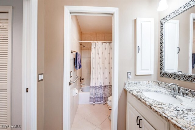 522 Countryside Dr, Naples, FL 34104 - bathroom featuring shower / tub combo with curtain, toilet, vanity, and tile patterned floors