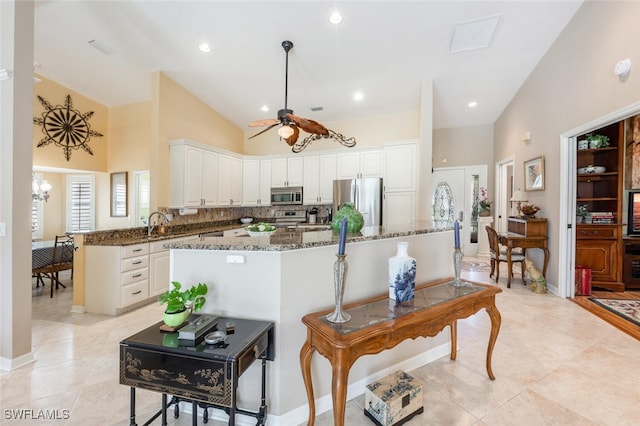 522 Countryside Dr, Naples, FL 34104 - kitchen featuring stainless steel appliances, white cabinetry, light tile patterned flooring, dark stone counters, and ceiling fan