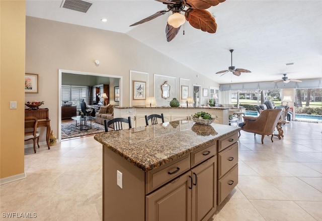 522 Countryside Dr, Naples, FL 34104 - kitchen with lofted ceiling, open floor plan, visible vents, and a kitchen island