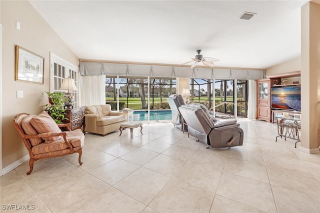 522 Countryside Dr, Naples, FL 34104 - living room with light tile patterned floors, vaulted ceiling, visible vents, and ceiling fan