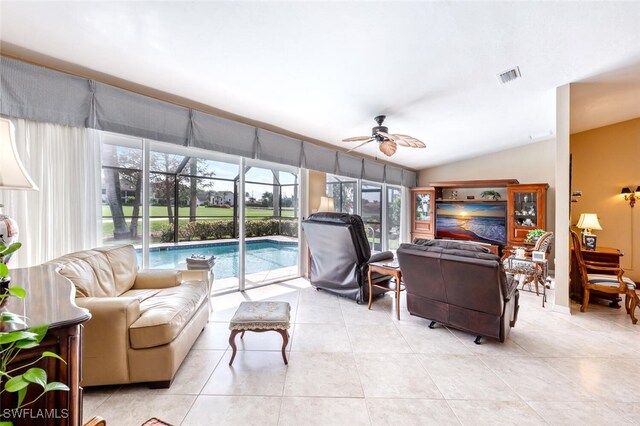 522 Countryside Dr, Naples, FL 34104 - living room with ceiling fan, lofted ceiling, visible vents, and light tile patterned floors