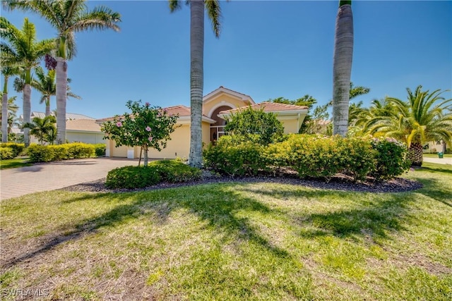 2620 Stonyhill Ct, Cape Coral, FL 33991 - view of front facade with stucco siding, driveway, and a front yard