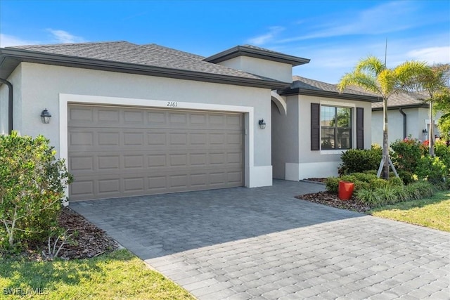 2161 Gardenia Ave, Port Charlotte, FL 33953 - ranch-style home with a garage, roof with shingles, decorative driveway, and stucco siding