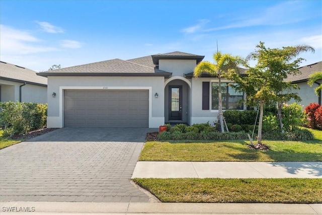 2161 Gardenia Ave, Port Charlotte, FL 33953 - ranch-style home featuring an attached garage, a front yard, decorative driveway, and stucco siding