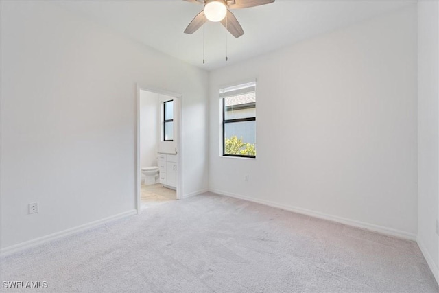 2161 Gardenia Ave, Port Charlotte, FL 33953 - unfurnished bedroom featuring baseboards, light carpet, and connected bathroom