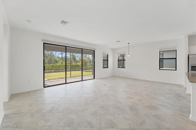 2161 Gardenia Ave, Port Charlotte, FL 33953 - unfurnished living room with visible vents and light tile patterned floors