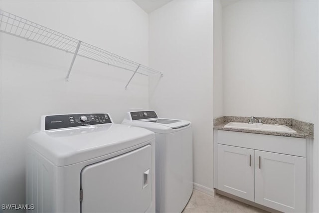 2161 Gardenia Ave, Port Charlotte, FL 33953 - laundry room featuring separate washer and dryer, cabinet space, and a sink