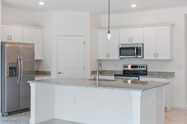 2161 Gardenia Ave, Port Charlotte, FL 33953 - kitchen featuring stainless steel appliances, a sink, a center island with sink, hanging light fixtures, and white cabinetry