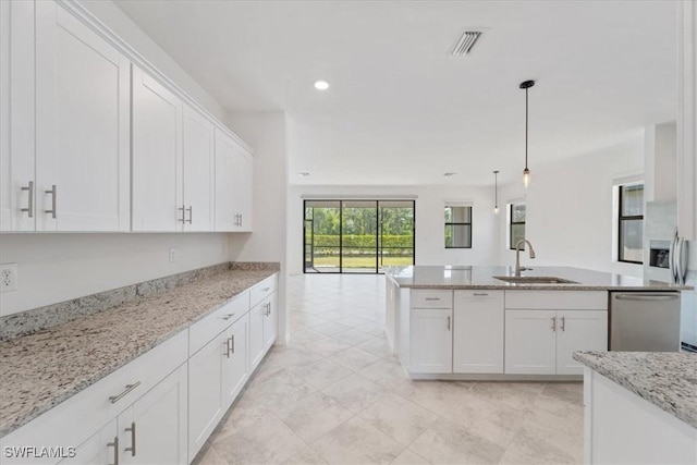 2161 Gardenia Ave, Port Charlotte, FL 33953 - kitchen with white cabinets, dishwasher, visible vents, a sink, and open floor plan