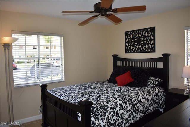 bedroom featuring baseboards and ceiling fan