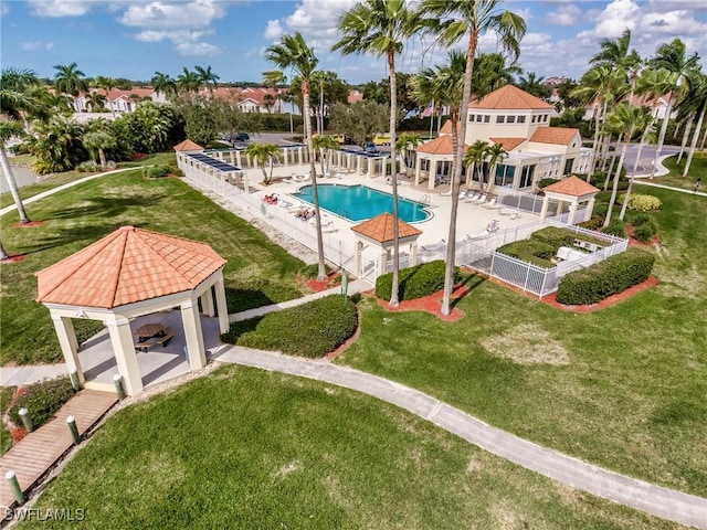 community pool with a patio area, a fenced backyard, a gazebo, and a yard