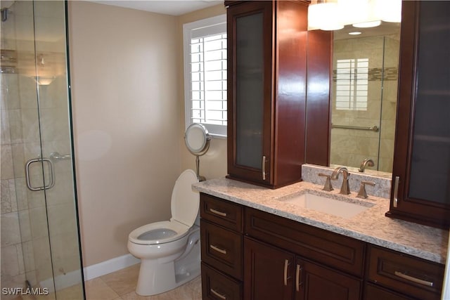 full bath with a shower stall, tile patterned flooring, toilet, vanity, and baseboards