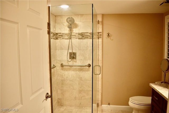 bathroom with visible vents, vanity, a shower stall, and toilet
