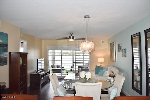dining space featuring baseboards, dark wood-type flooring, and ceiling fan with notable chandelier