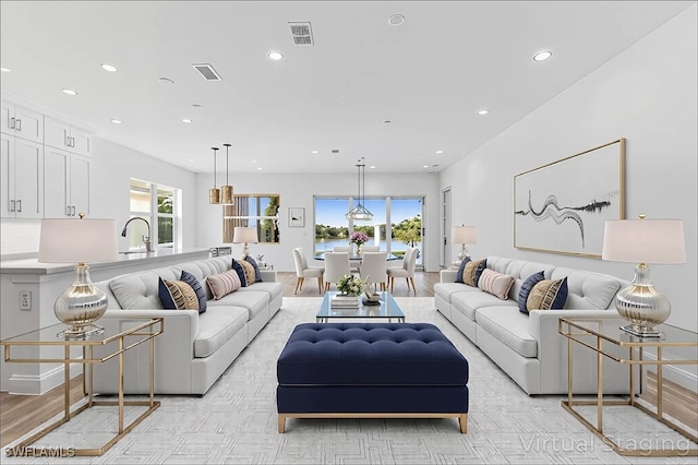 living area with recessed lighting and visible vents