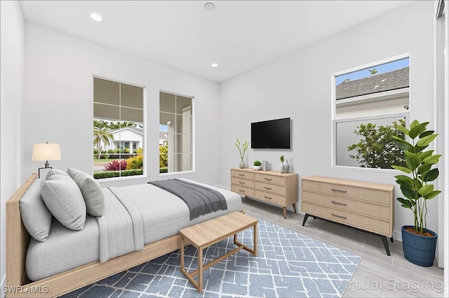 bedroom featuring wood finished floors, recessed lighting, and baseboards