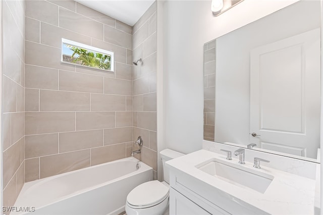 bathroom featuring toilet, washtub / shower combination, and vanity