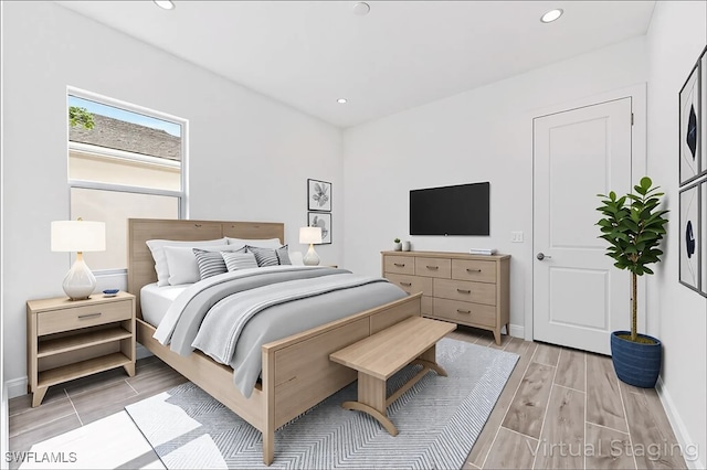 bedroom featuring wood tiled floor, recessed lighting, and baseboards