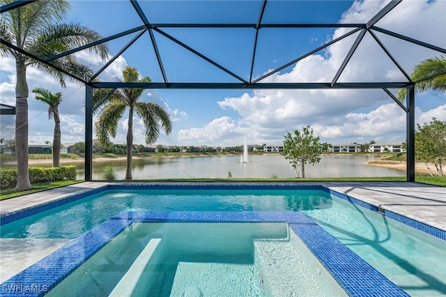 8786 Saint Lucia Dr, Naples, FL 34114 - view of swimming pool featuring a water view, a lanai, and a pool with connected hot tub