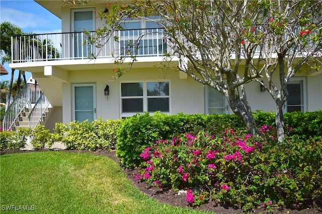 240 N Collier Blvd Unit G1, Marco Island, FL 34145 - exterior space with stairway, a balcony, and a yard