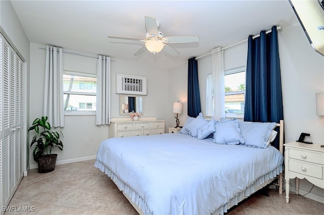 240 N Collier Blvd Unit G1, Marco Island, FL 34145 - bedroom featuring multiple windows, light tile patterned floors, a ceiling fan, and a closet