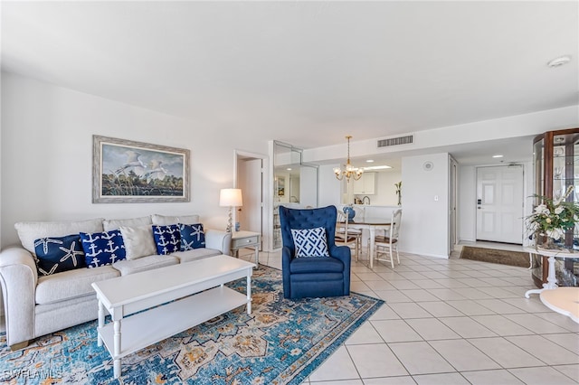 living room with a chandelier, visible vents, and light tile patterned flooring