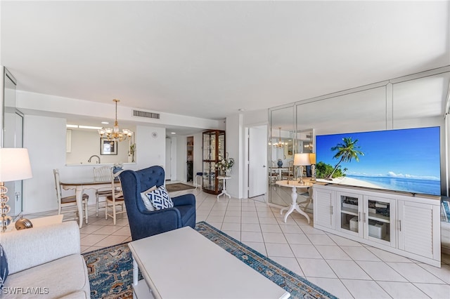 living area with an inviting chandelier, visible vents, and light tile patterned flooring