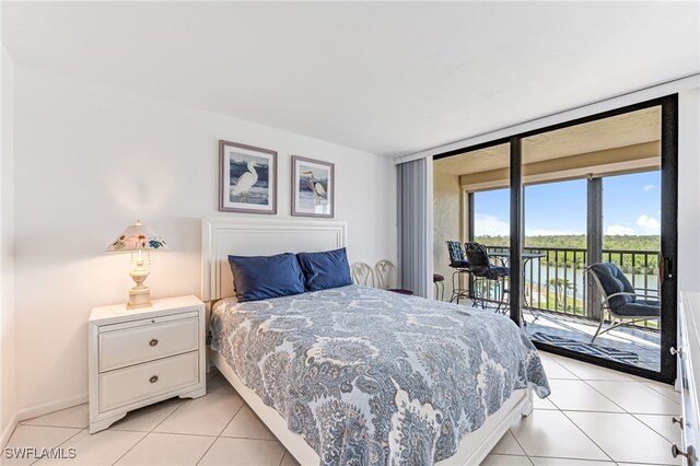 bedroom featuring light tile patterned floors, access to outside, and baseboards