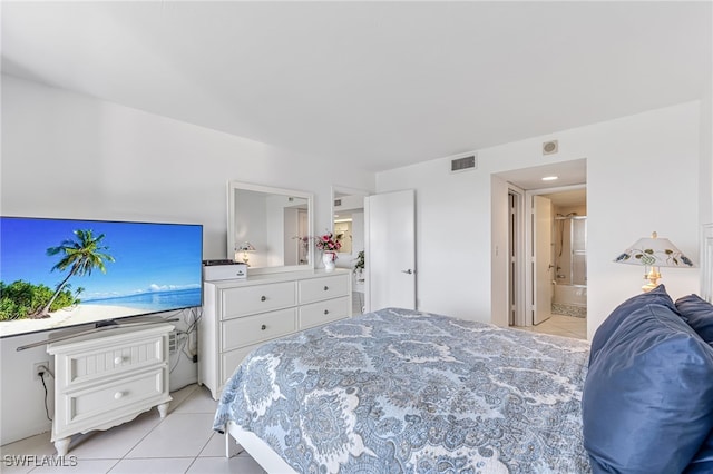 bedroom featuring light tile patterned flooring, ensuite bathroom, and visible vents
