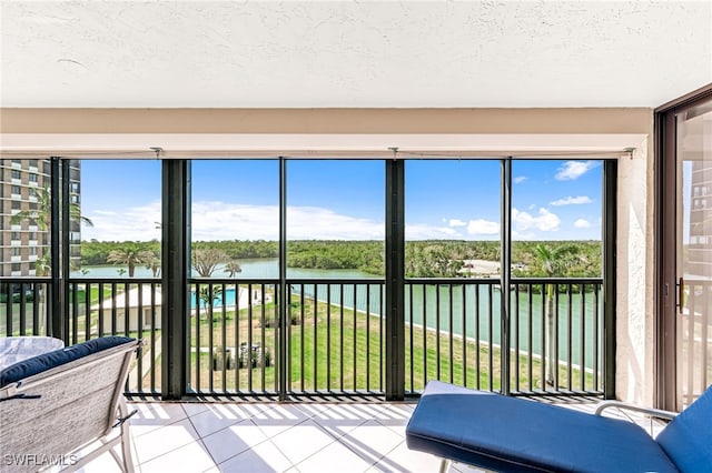 sunroom / solarium with a water view and a wealth of natural light