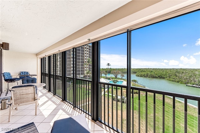 sunroom / solarium with a water view