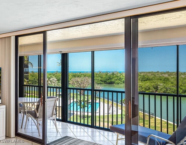 entryway featuring a water view and tile patterned flooring
