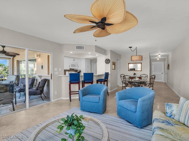 900 Collier Ct Unit 106, Marco Island, FL 34145 - living area featuring ceiling fan, a wealth of natural light, visible vents, and baseboards