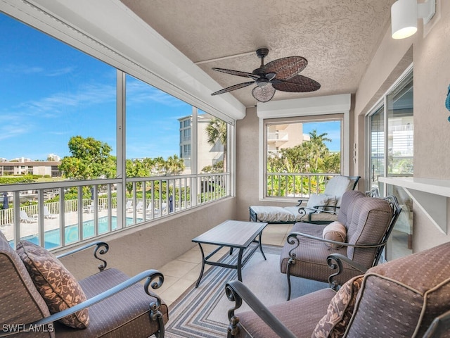900 Collier Ct Unit 106, Marco Island, FL 34145 - sunroom / solarium featuring a textured ceiling, a ceiling fan, and tile patterned floors