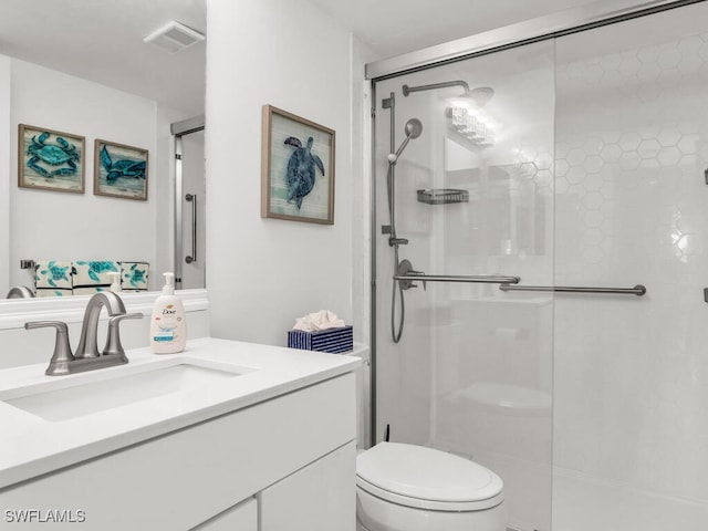 900 Collier Ct Unit 106, Marco Island, FL 34145 - bathroom with toilet, vanity, visible vents, and a stall shower