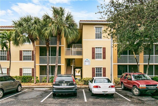 4121 Residence Dr Unit 303, Fort Myers, FL 33901 - view of property featuring uncovered parking