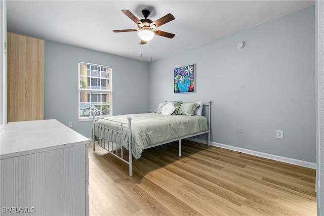 4121 Residence Dr Unit 303, Fort Myers, FL 33901 - bedroom featuring light wood-style floors, a ceiling fan, and baseboards