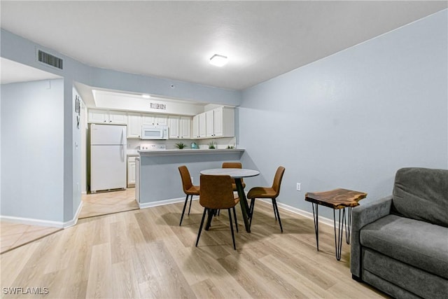 4121 Residence Dr Unit 303, Fort Myers, FL 33901 - dining room with light wood-style floors, visible vents, and baseboards