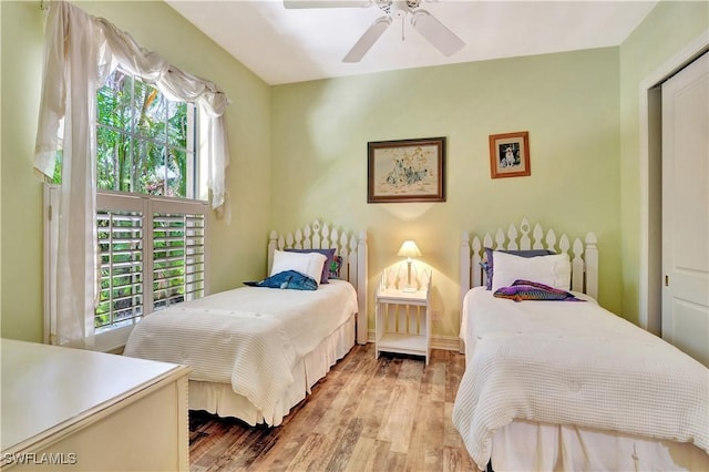 2363 Crayton Rd, Naples, FL 34103 - bedroom with multiple windows, wood finished floors, a ceiling fan, and baseboards