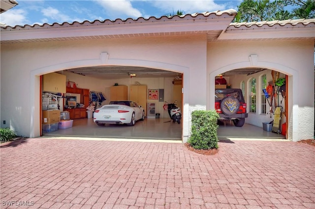2363 Crayton Rd, Naples, FL 34103 - garage featuring decorative driveway