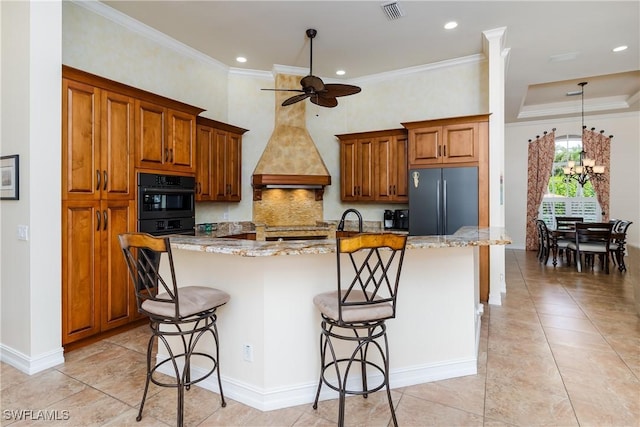 2363 Crayton Rd, Naples, FL 34103 - kitchen with freestanding refrigerator, black oven, brown cabinetry, a ceiling fan, and a breakfast bar area