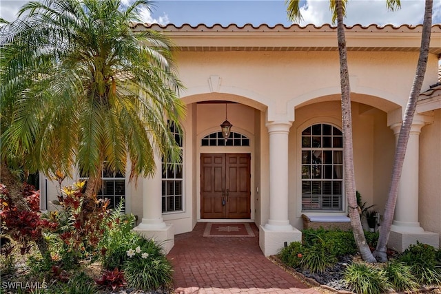 2363 Crayton Rd, Naples, FL 34103 - doorway to property featuring stucco siding