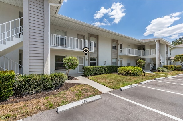 1350 Churchill Cir Unit L102, Naples, FL 34116 - view of property featuring uncovered parking
