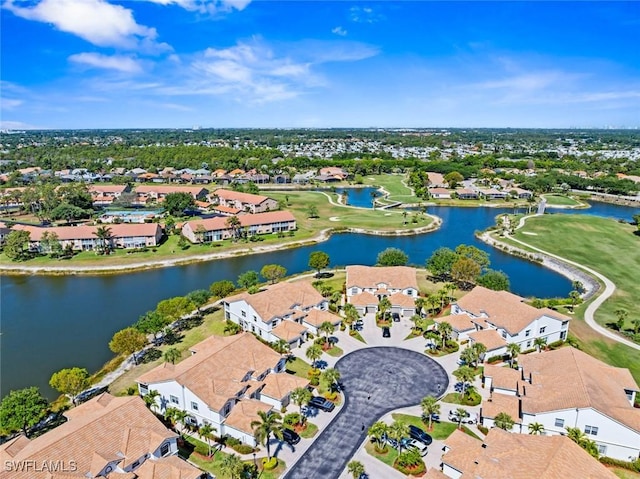 birds eye view of property featuring view of golf course, a residential view, and a water view