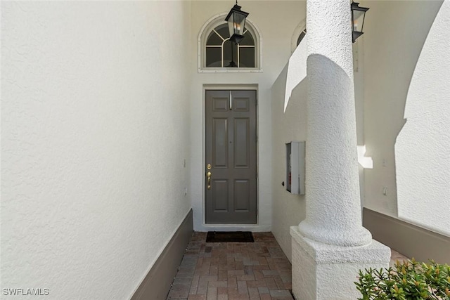 property entrance featuring stucco siding