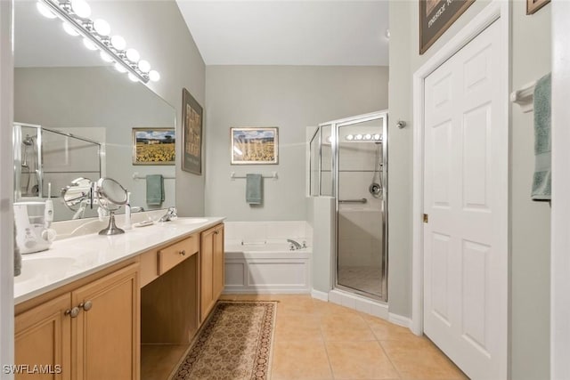 bathroom with a bath, tile patterned floors, a sink, double vanity, and a shower stall